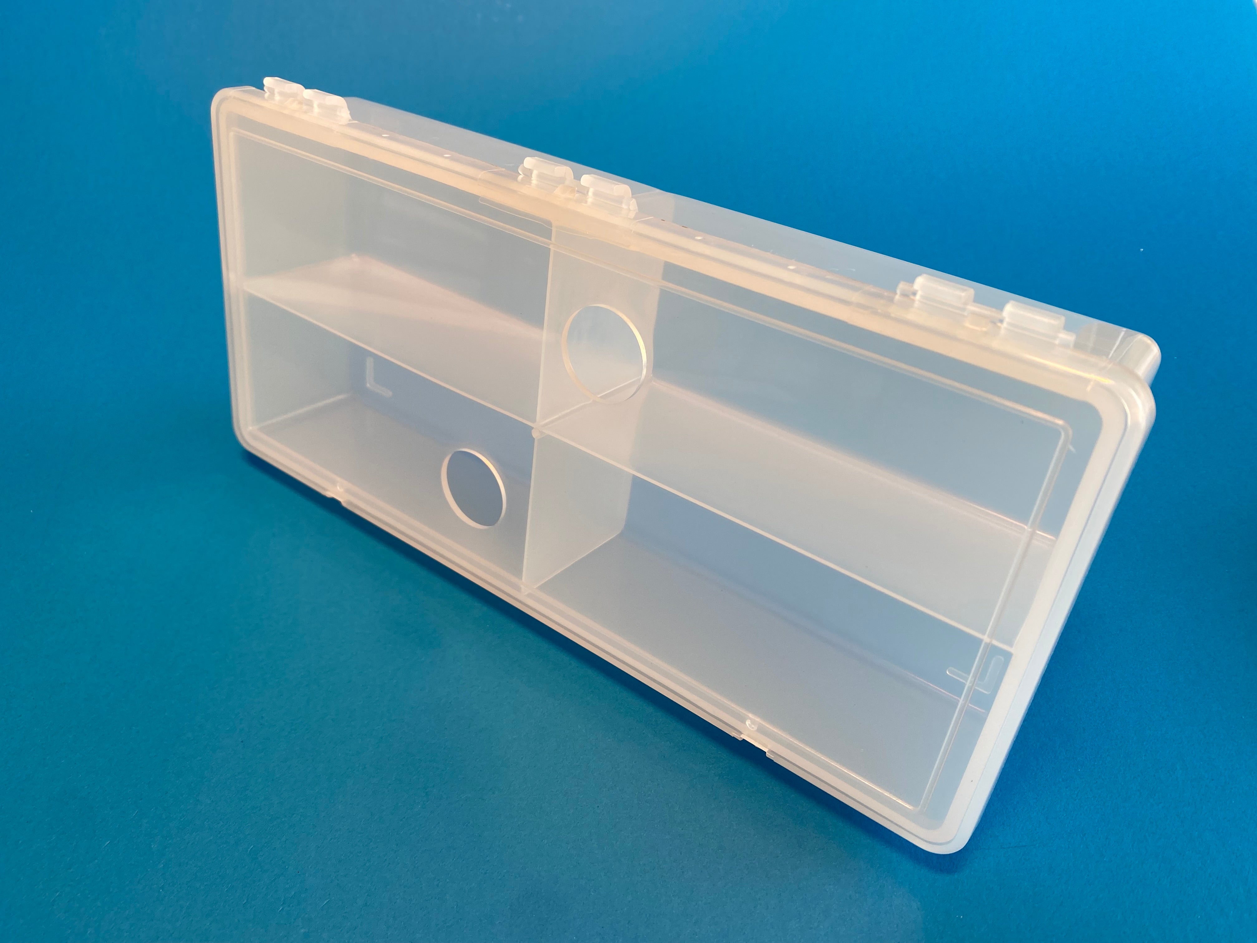 D54 case, 4 bays, with two finger holes in lid, molded in clear polypropylene, closed view 2