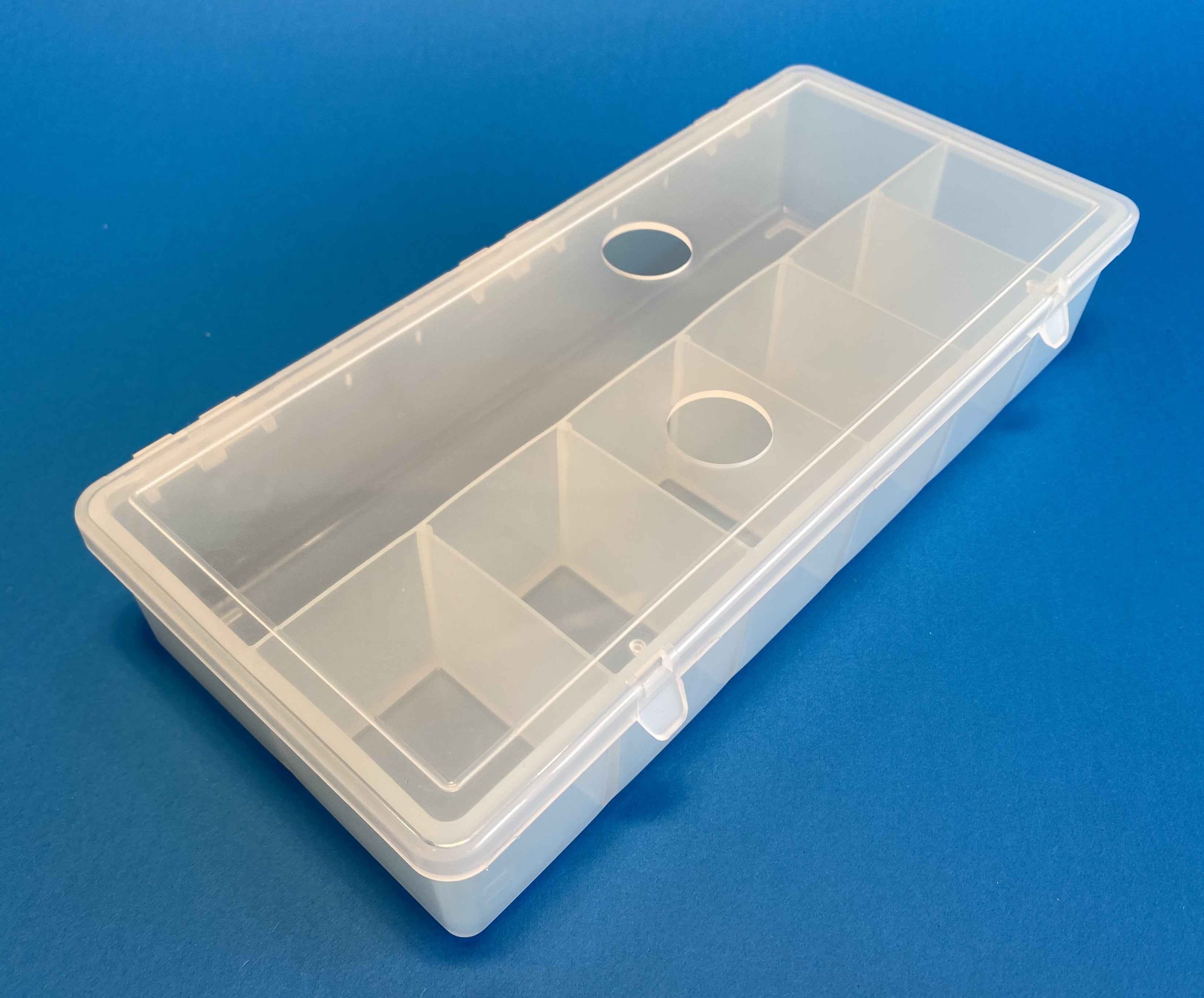 D54 case, 7 bays, with two finger holes in lid, molded in clear polypropylene, closed view 1