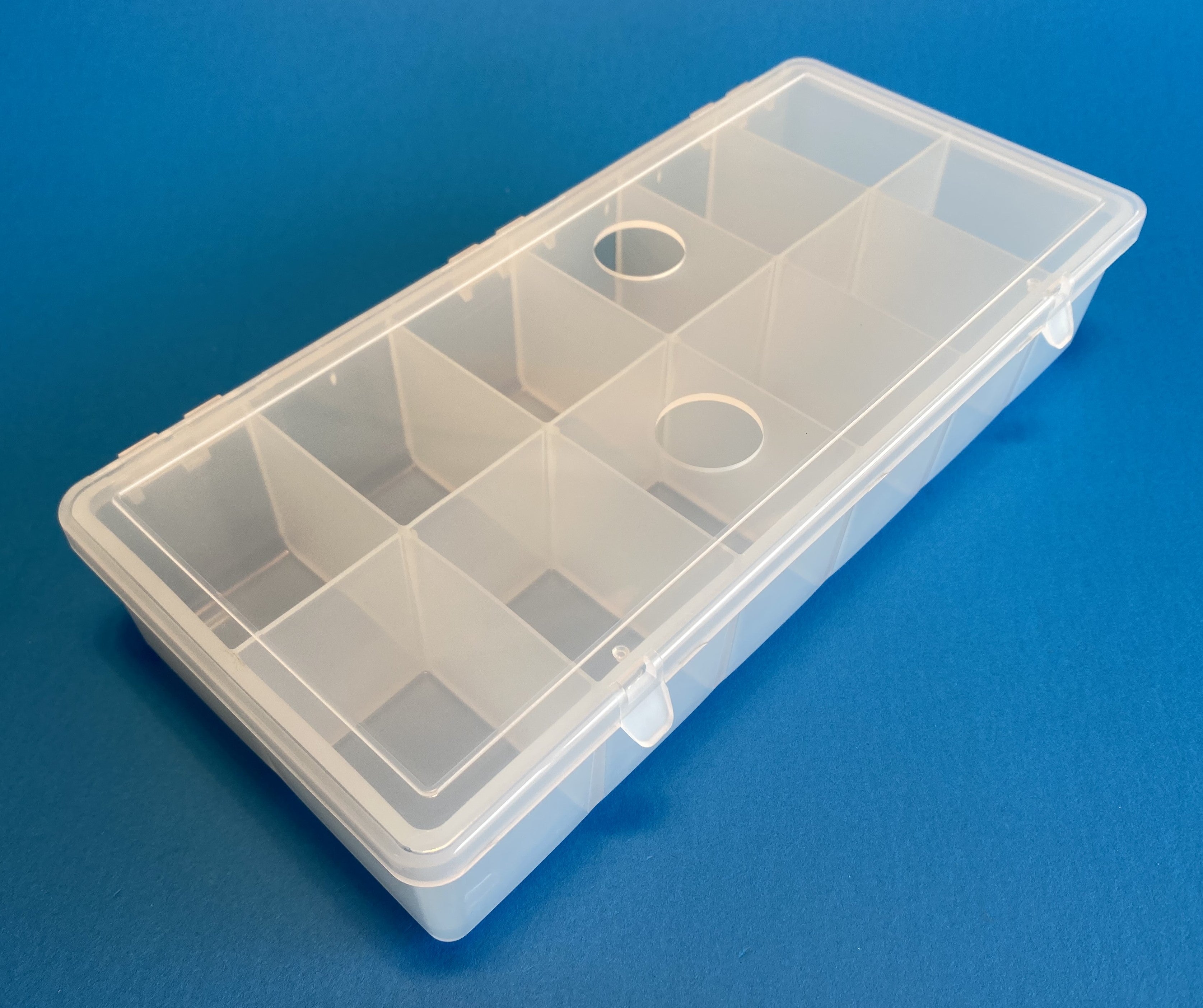 D54 case, 12 bays, with two finger holes in lid, molded in clear polypropylene, closed view 1