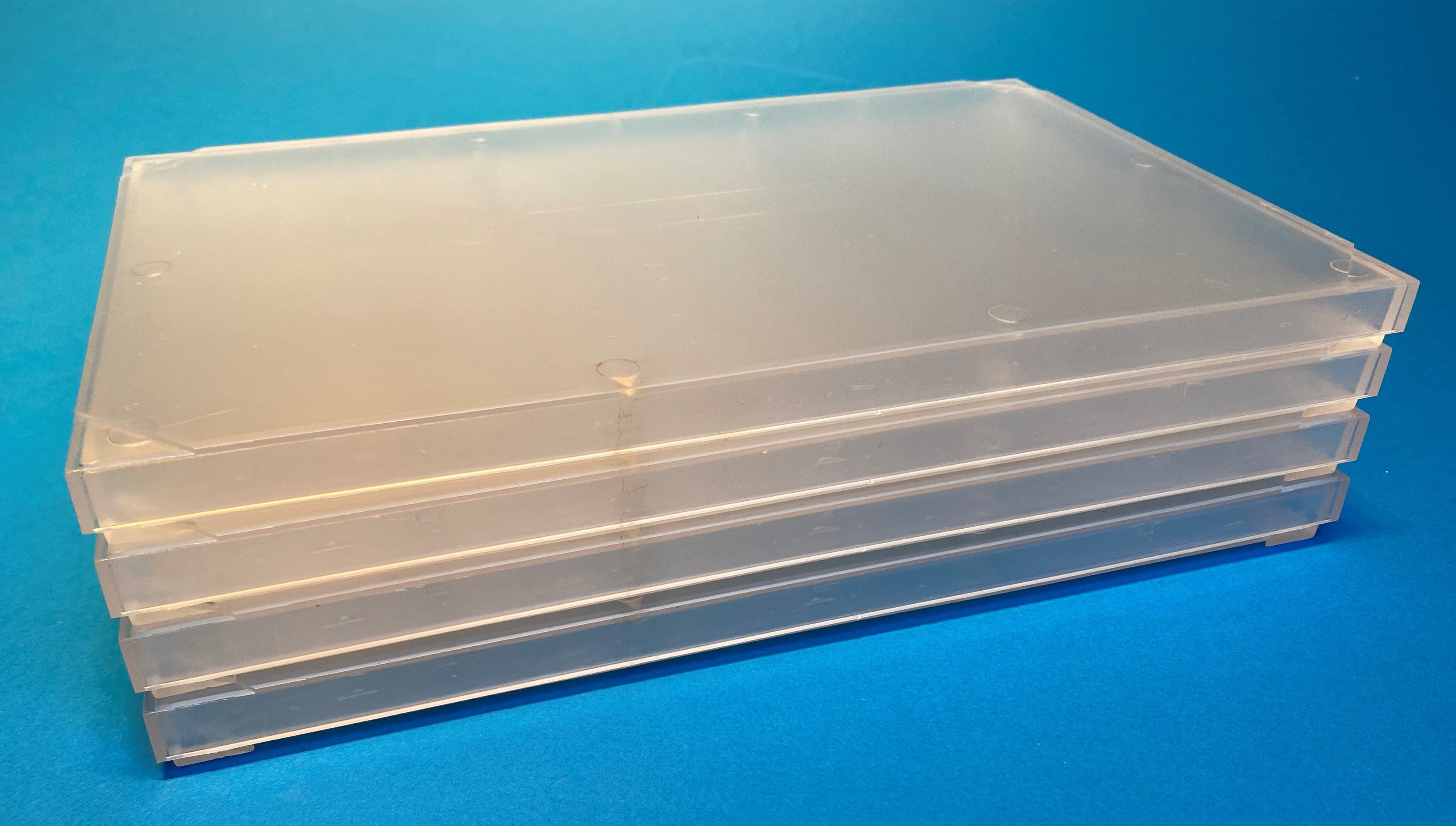 FTC case molded in clear impact-protected copolymer, stack of four parts