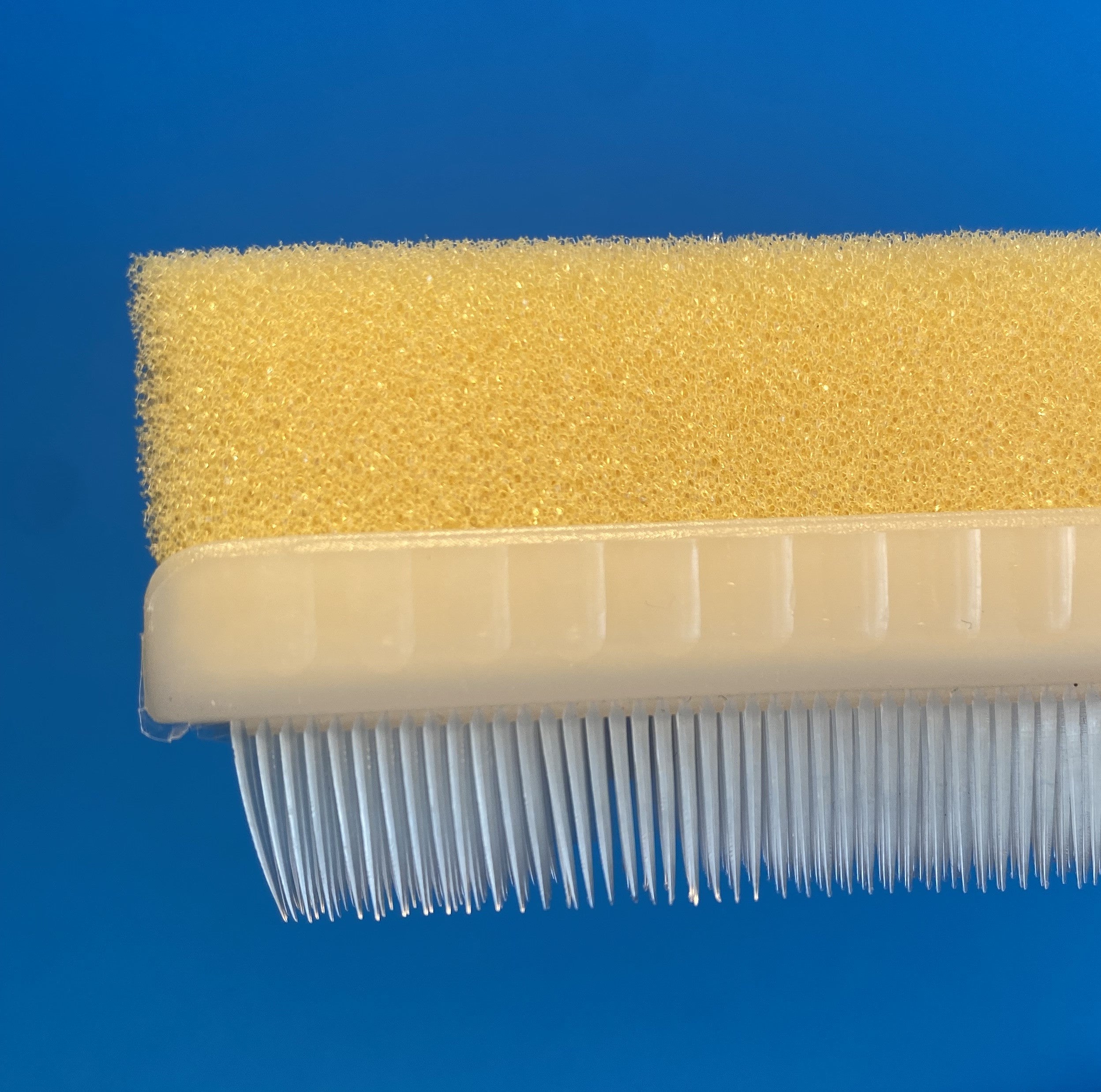 Surgical-style scrub brush for hands and nails, molded brush with foam attached, side view